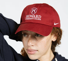 Load image into Gallery viewer, Person wearing a red &#39;Howard Community College&#39; cap with a Nike logo.