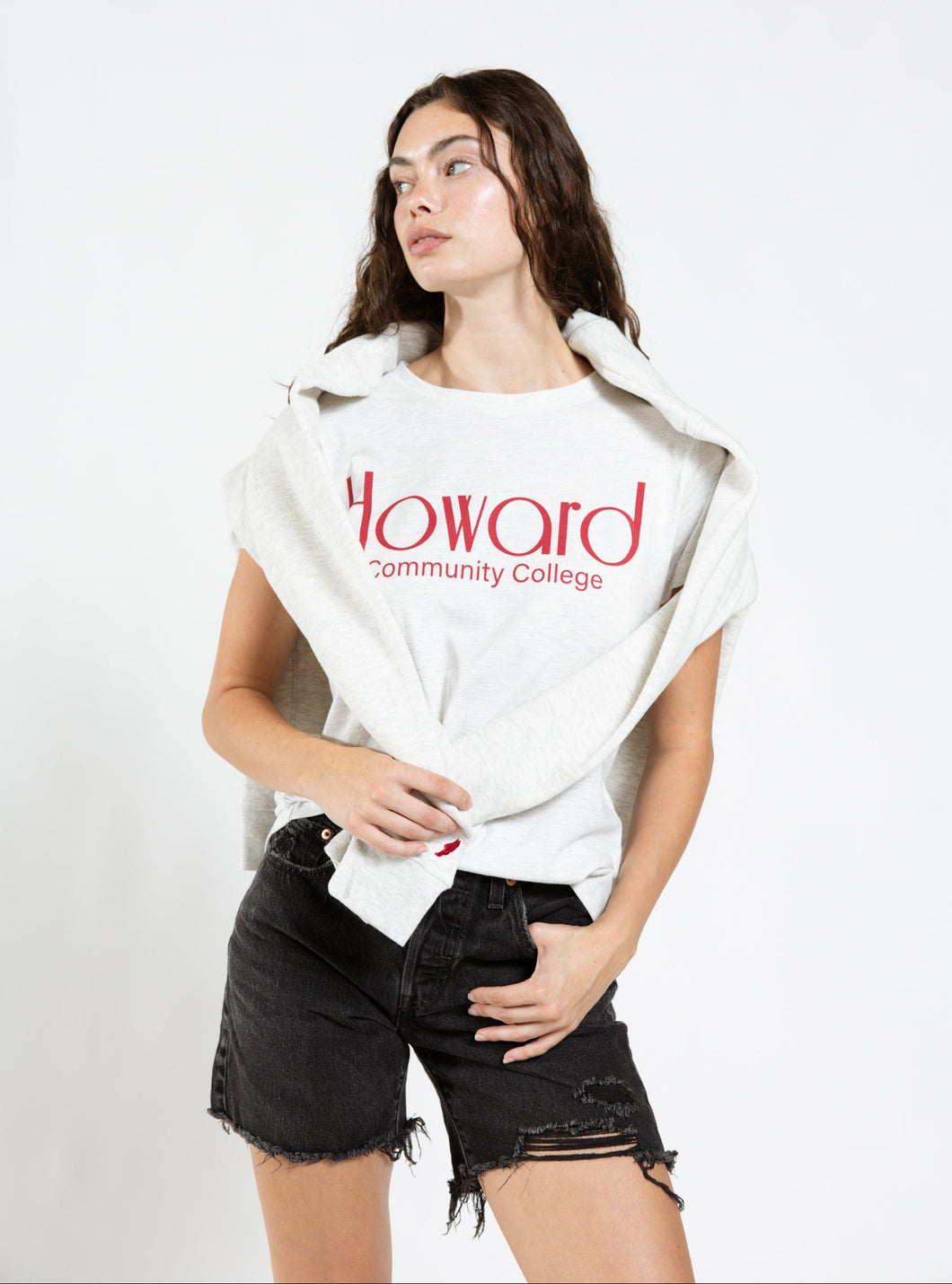Person wearing a white shirt with 'Howard Community College' text on a plain background